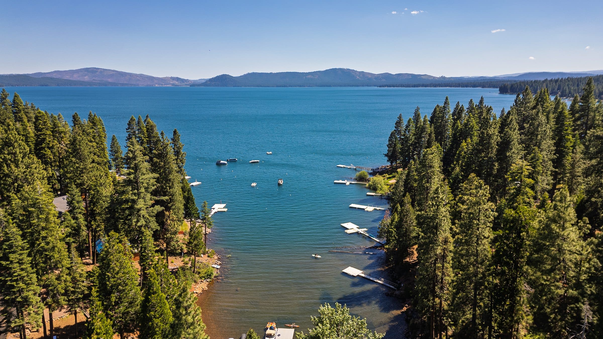 Lake Almanor framed by pines, seen from a lakeside lot on Peninsula Drive